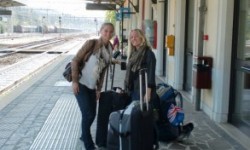 Waiting with luggage at a train station in Italy