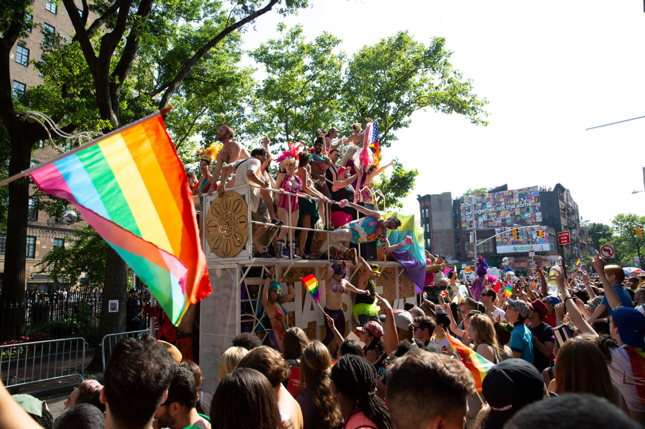 Crowds of people with rainbow flags at NYC Pride March