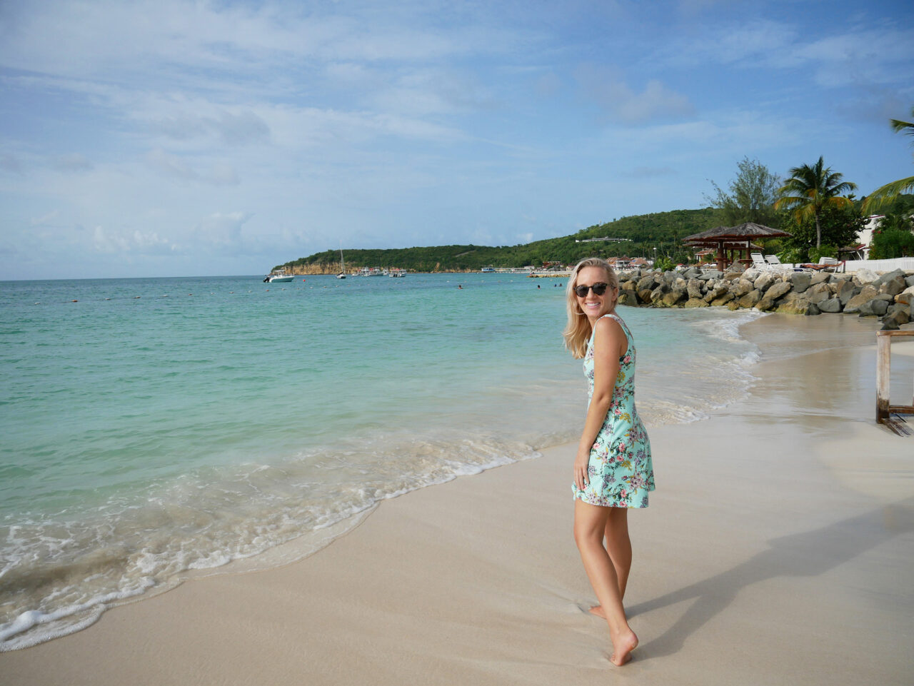 solo female traveler walking on beach in Antigua