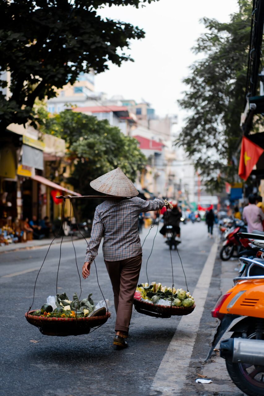 Vietnamese person walking down a street in Vietnam