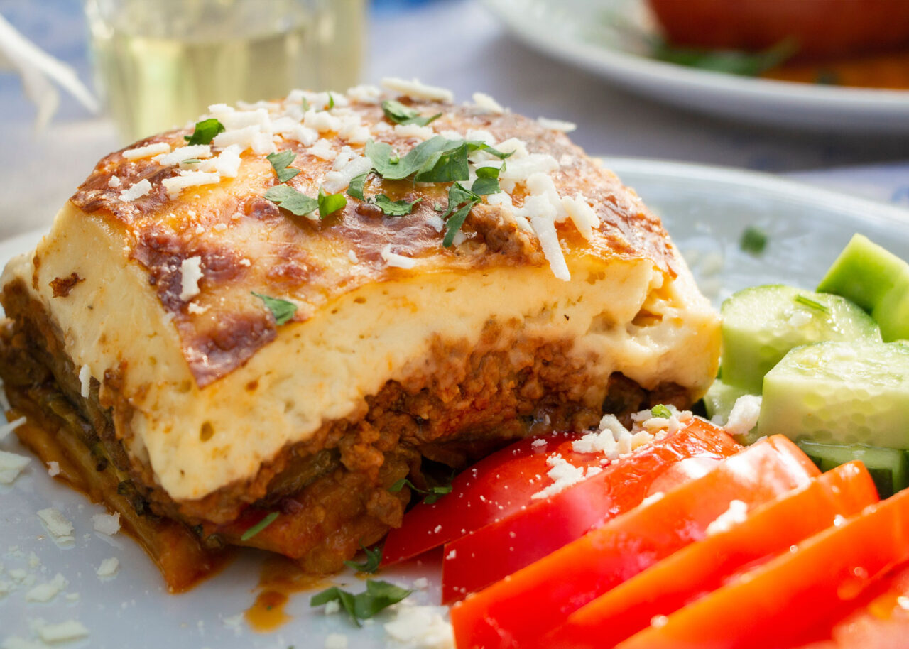 Greek traditional moussaka on a white plate served in taverna, Greece
