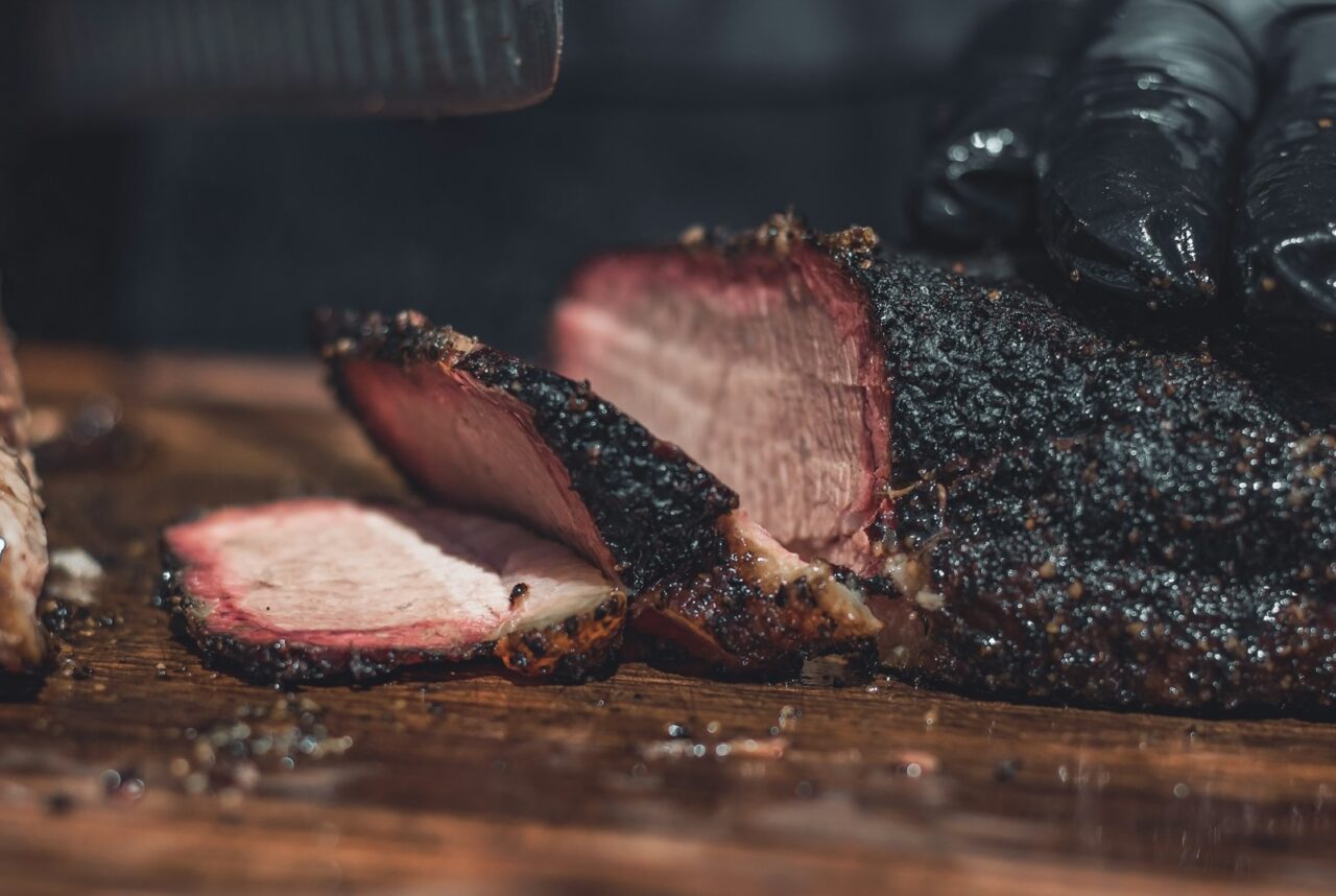 Person chopping up barbecue brisket