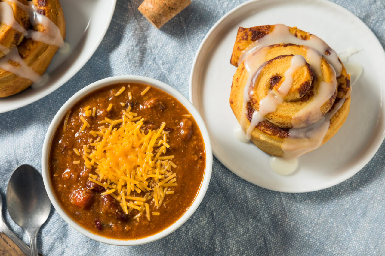 Bowl of chili and a cinnamon roll - popular food Kansas is known for