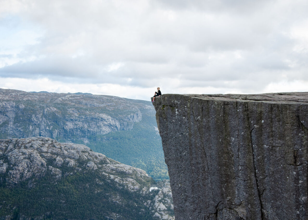 Sitting on the edge of Pulpit Rock, Norway