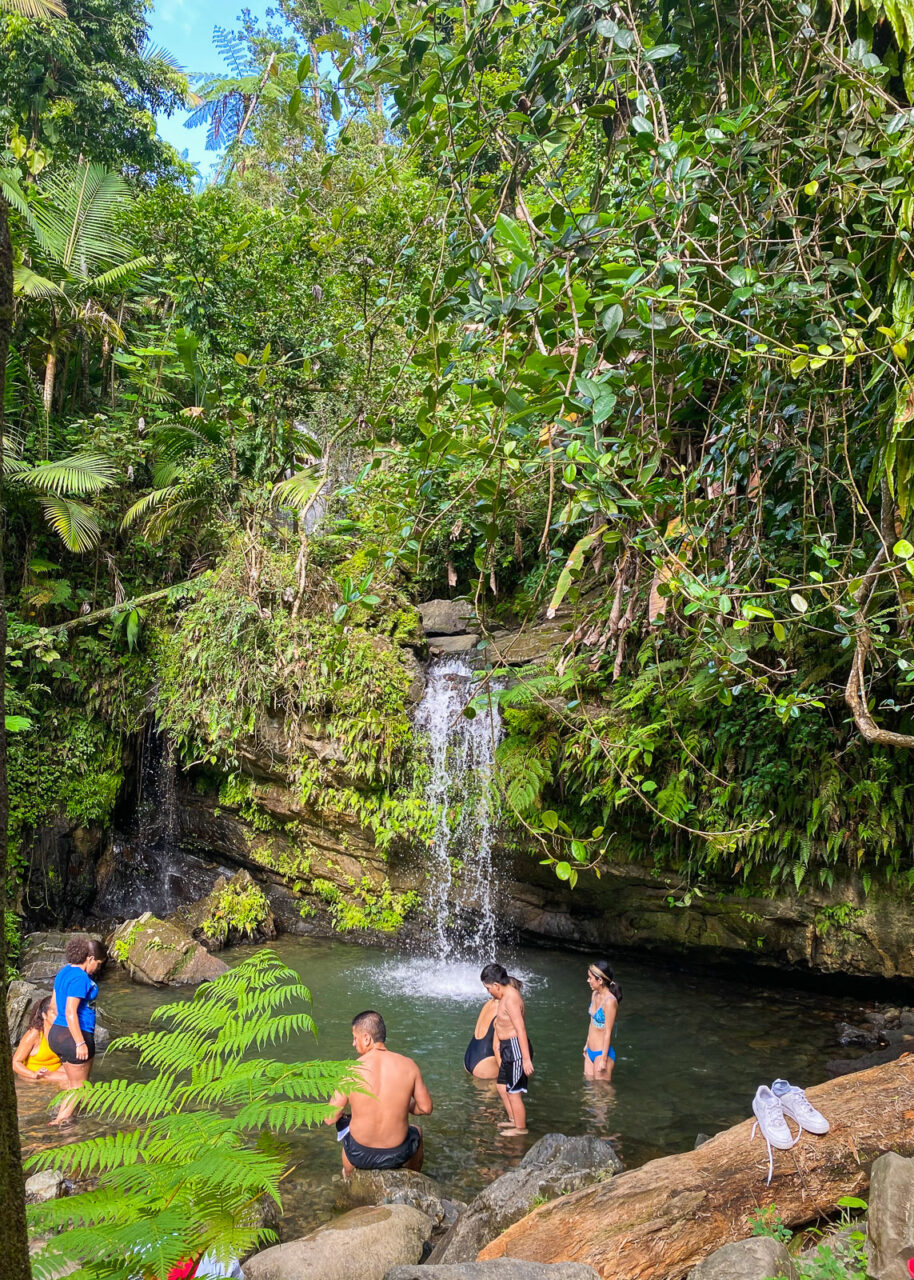 Family bathing in a waterfall in El Yunque rainforest