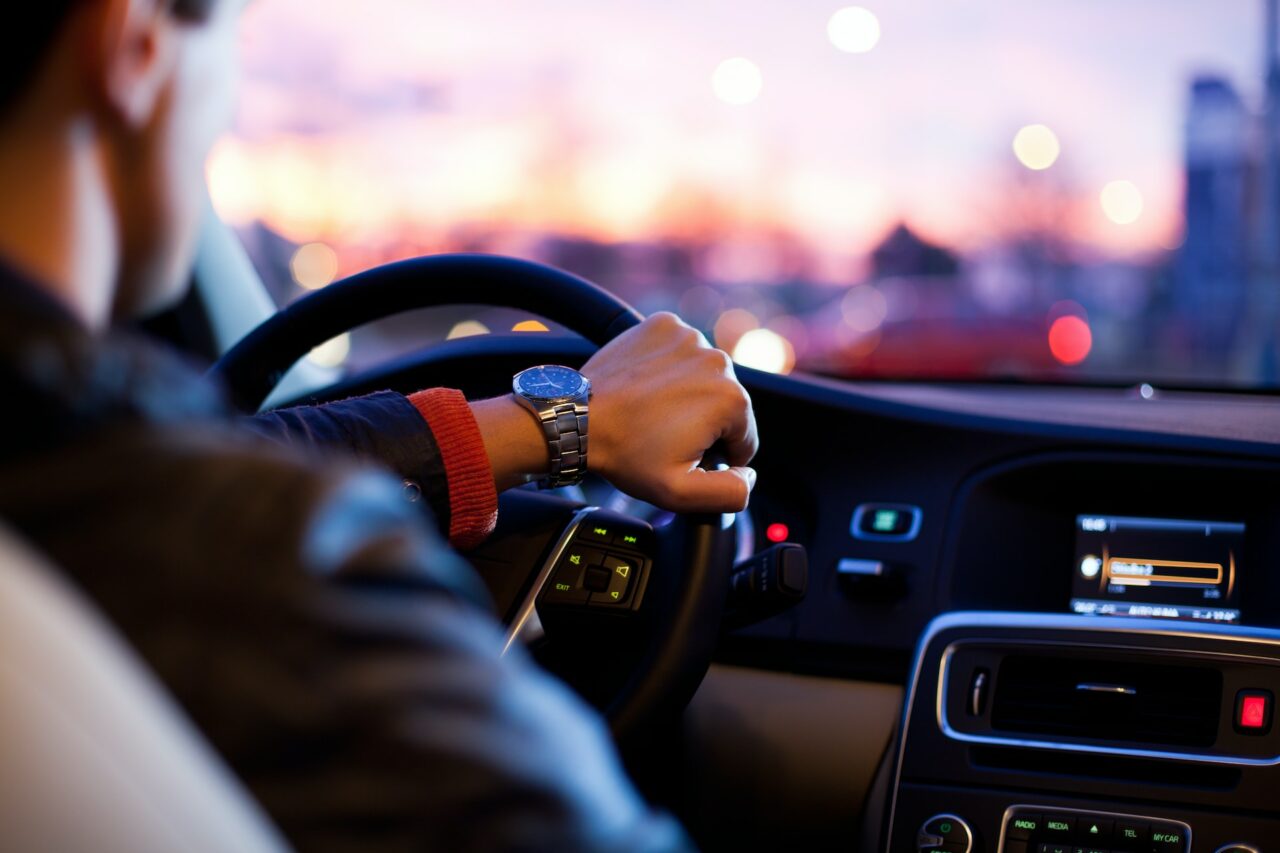 Man driving a car wearing a wrist watch