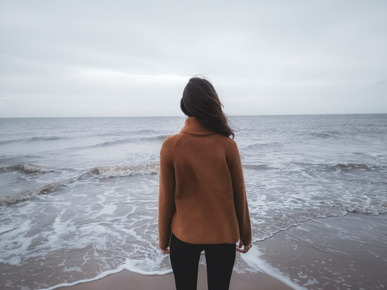 Woman standing next to the ocean