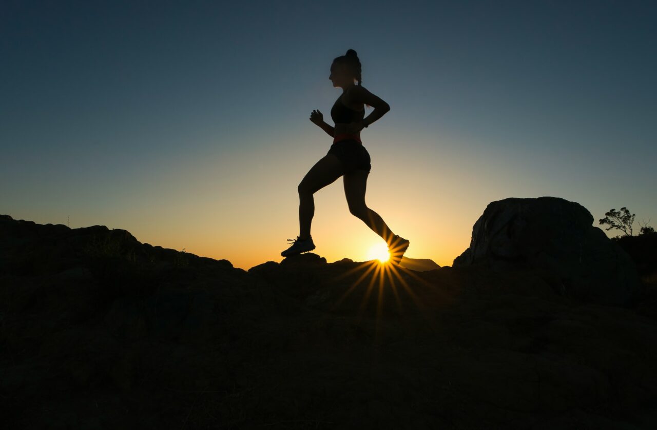 Woman running up a trail