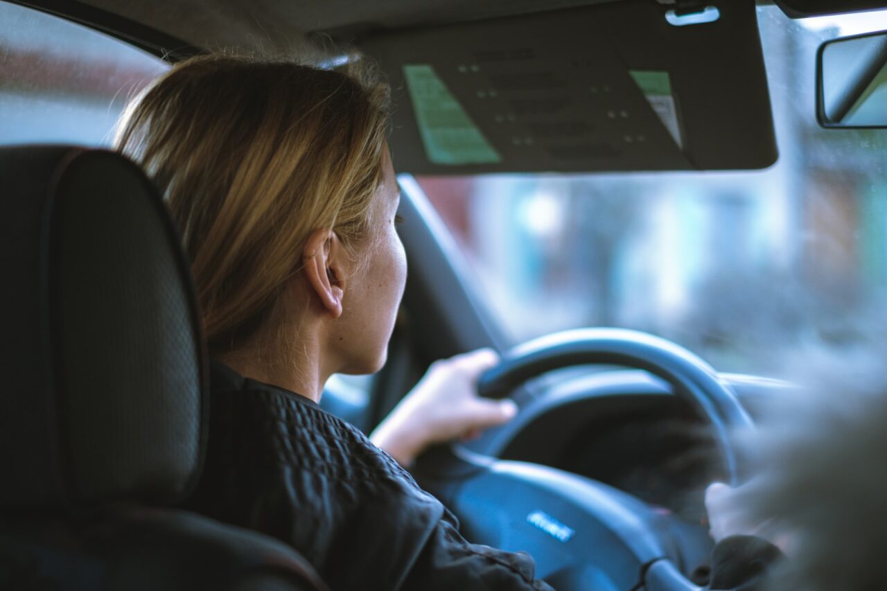 Woman behind the wheel of a car driving