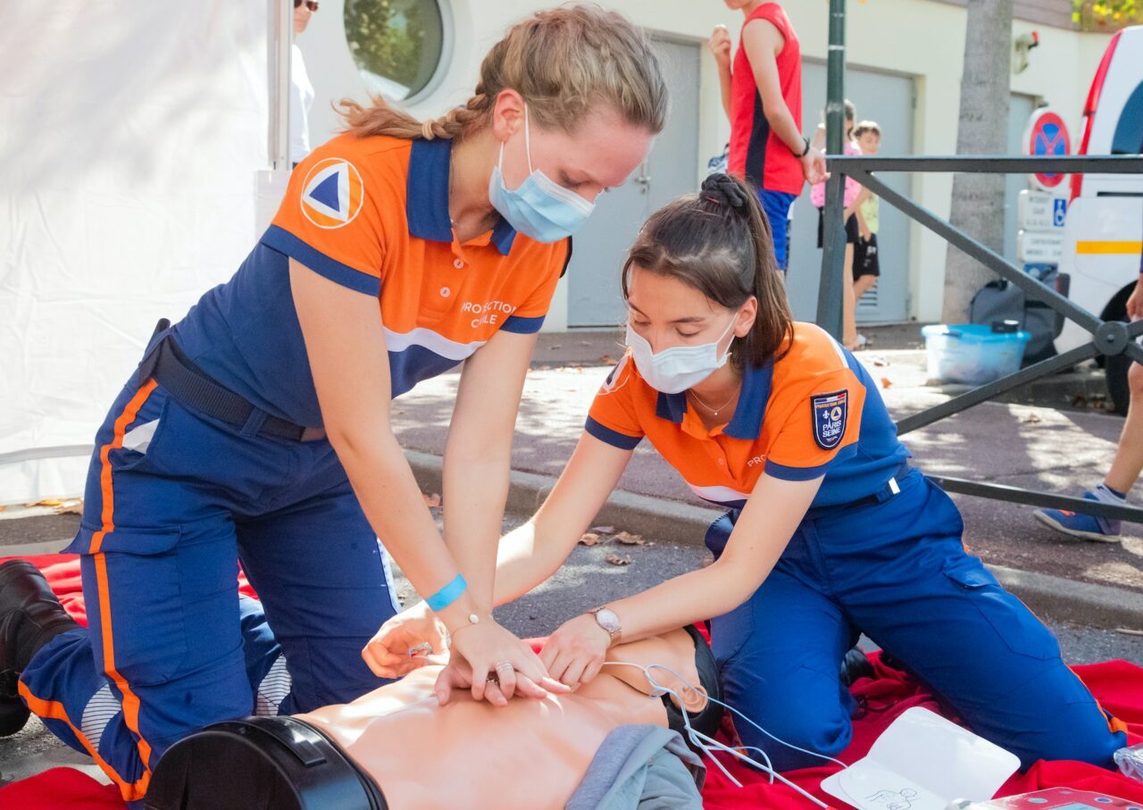 Two women practicing CPR