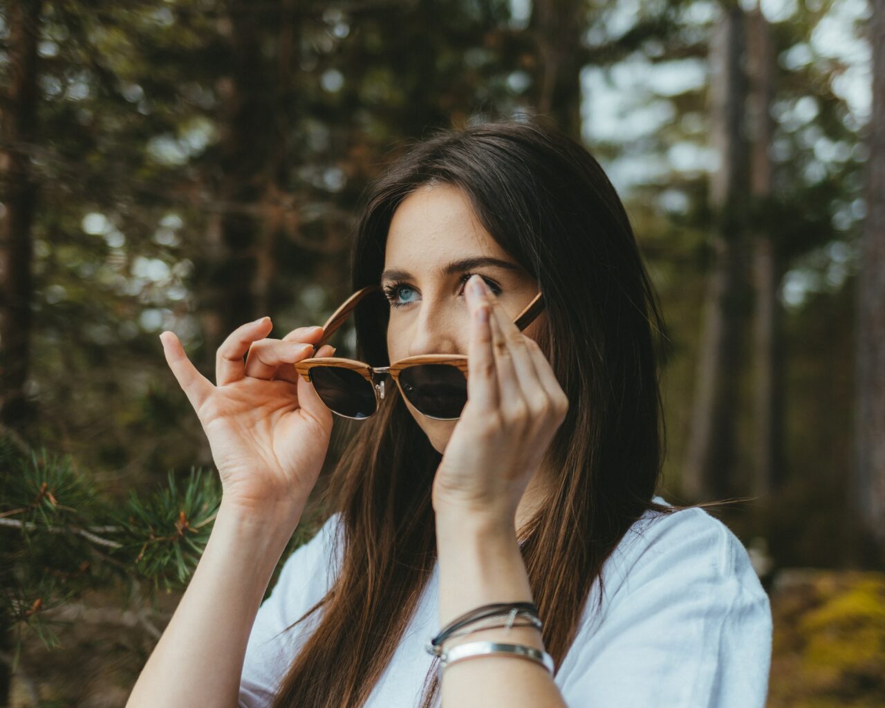 Woman putting on sunglasses