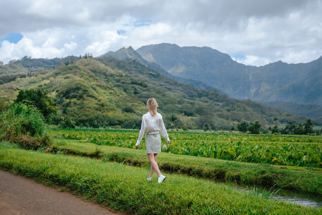 Woman walking through a field in Hanalei, Hawaii