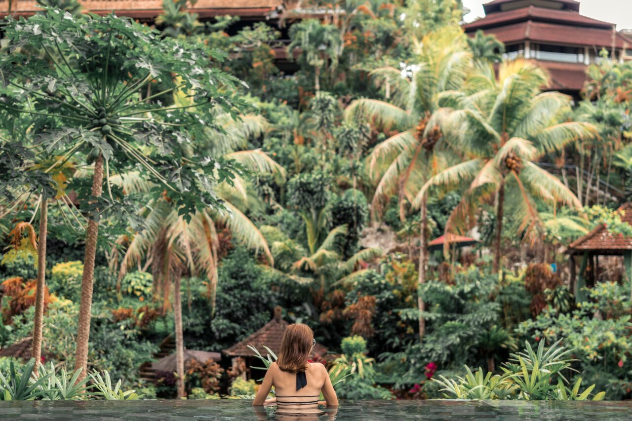 Woman in an infinity pool in the jungle in Bali Indonesia