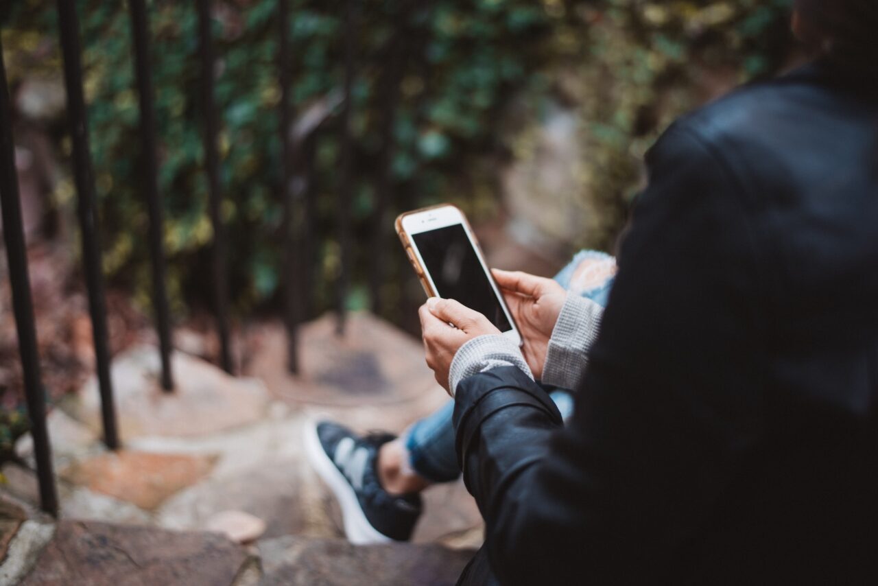 Close up of a woman holding an iphone