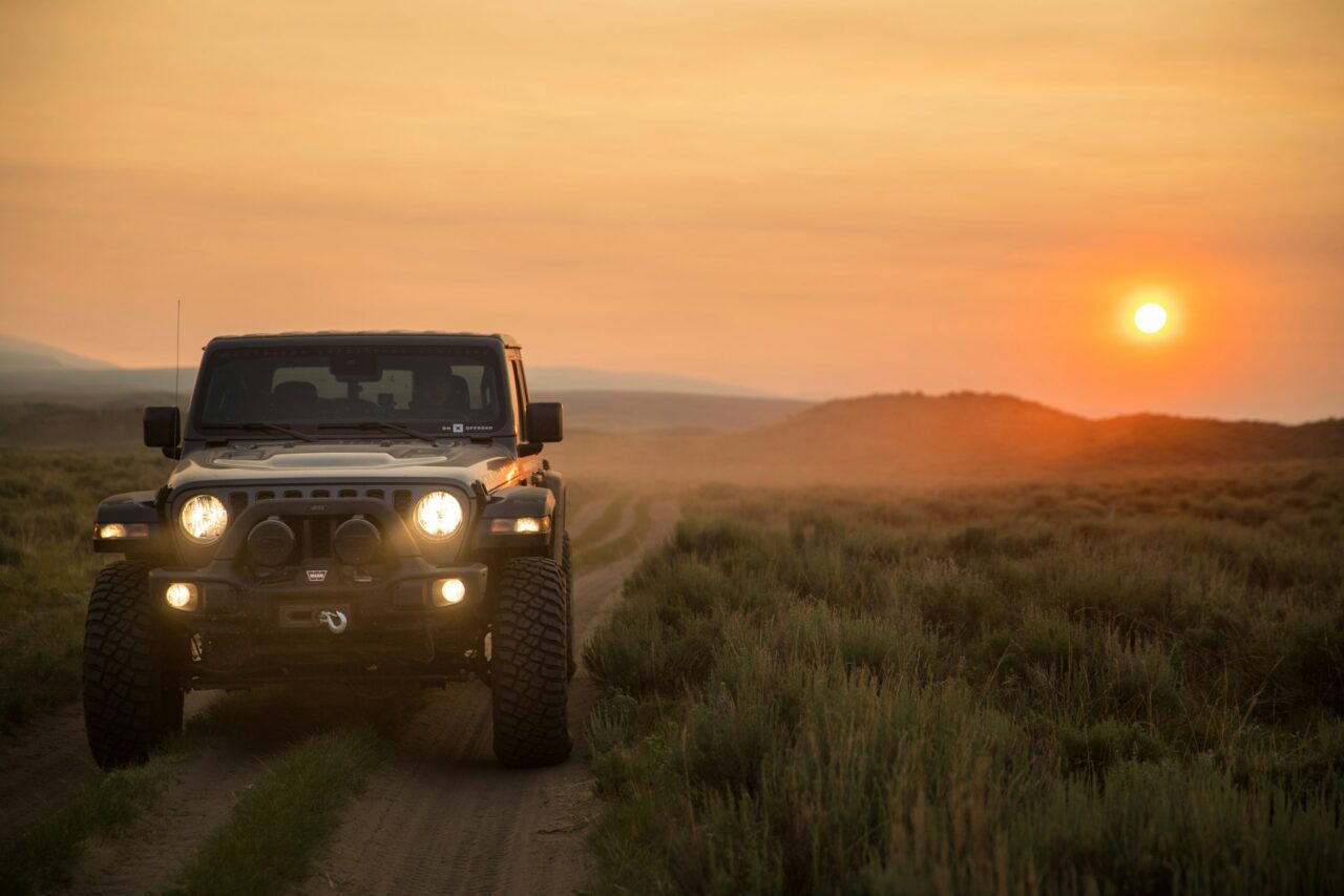 4X4 vehicle on a dirt road at sunset
