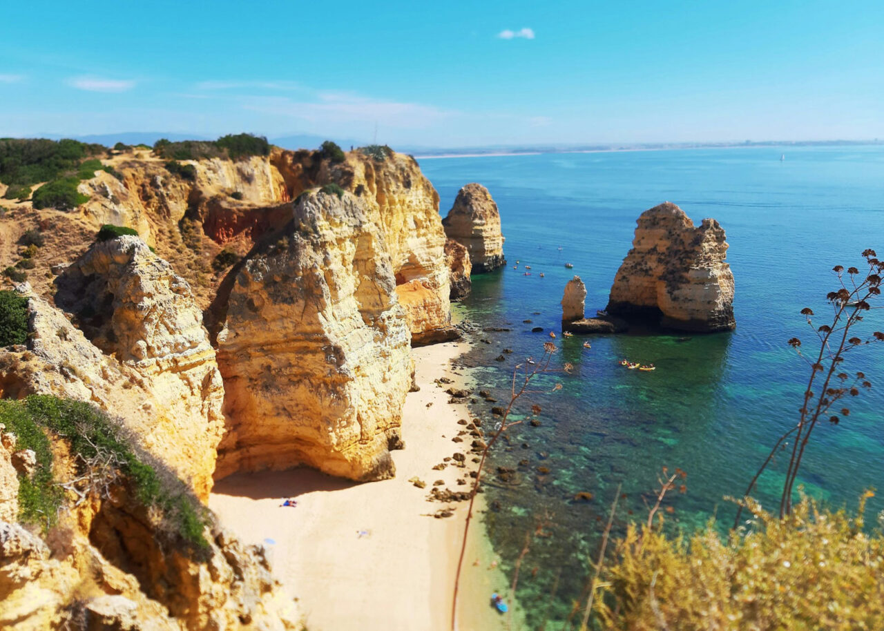 Beach with tall yellow cliffs and rock formations at Ponta da Piedade, Lagos