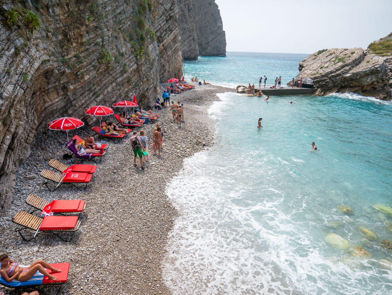 Small rocky beach with lounge chairs on Sveti Nikola