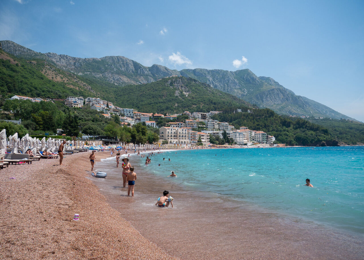 Pink sand and blue waters at Sveti Stefan beach in Montenegro