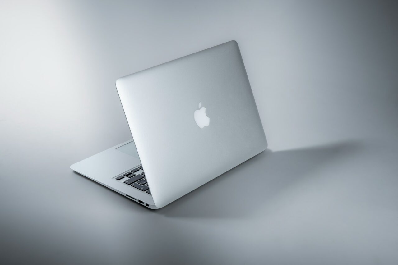 Silver Apple MacBook computer on a plain grey background