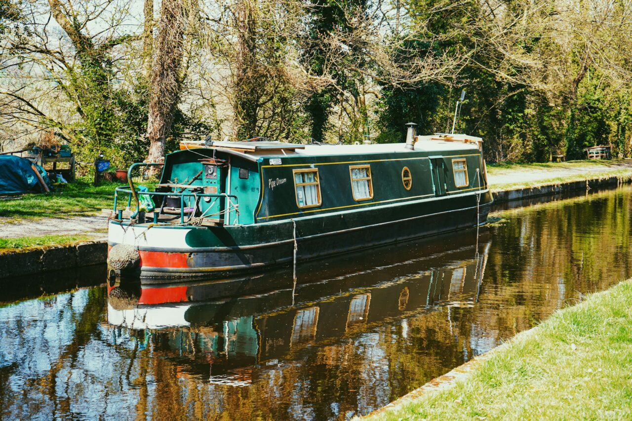 Green canal boat on a canal