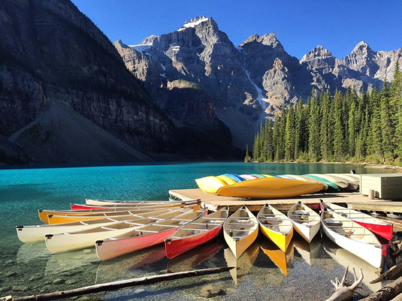 Canoes next to a lake with mountains in Banff National Park