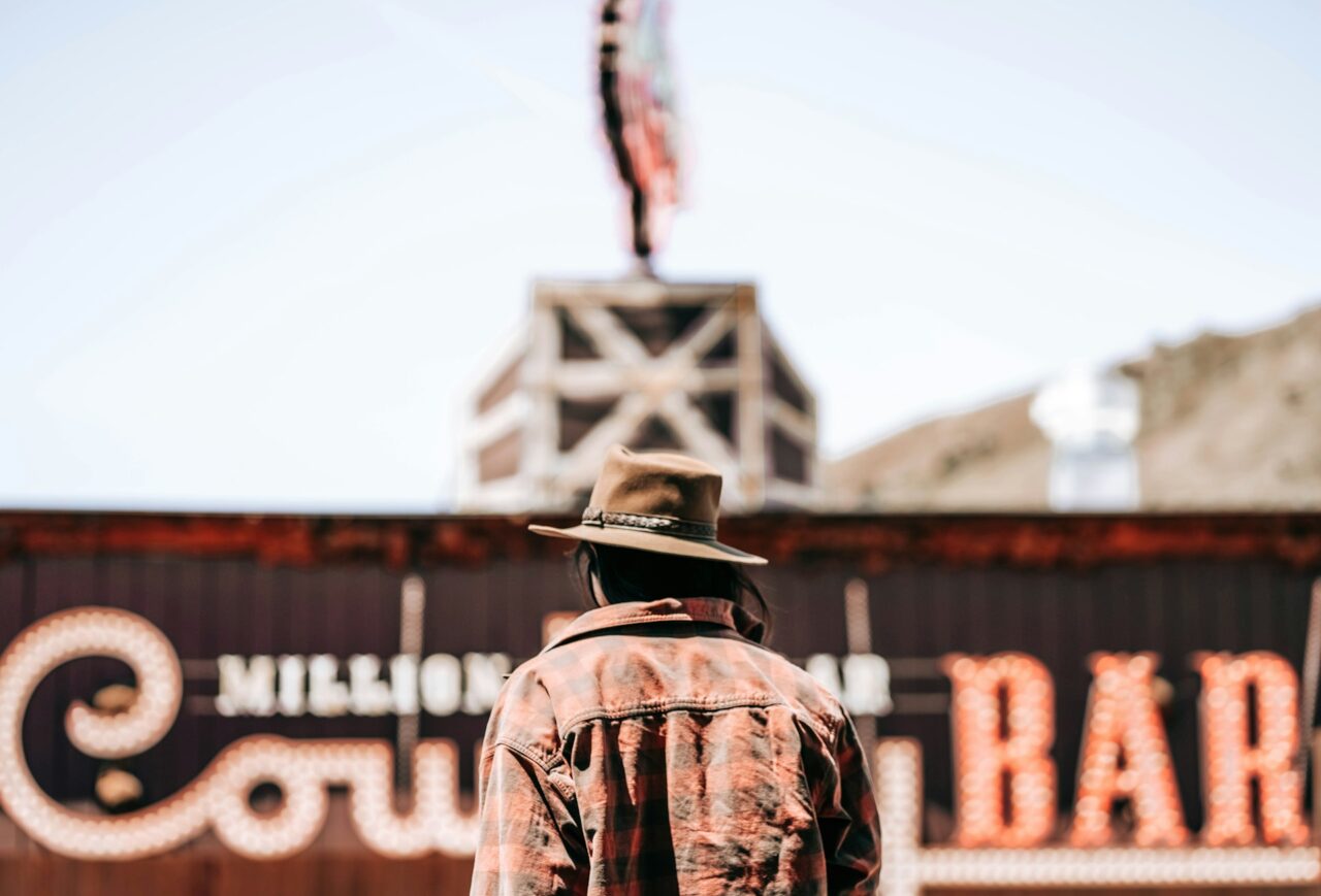 Man in a cowboy hat walking towards Cowboy Bar in Wyoming