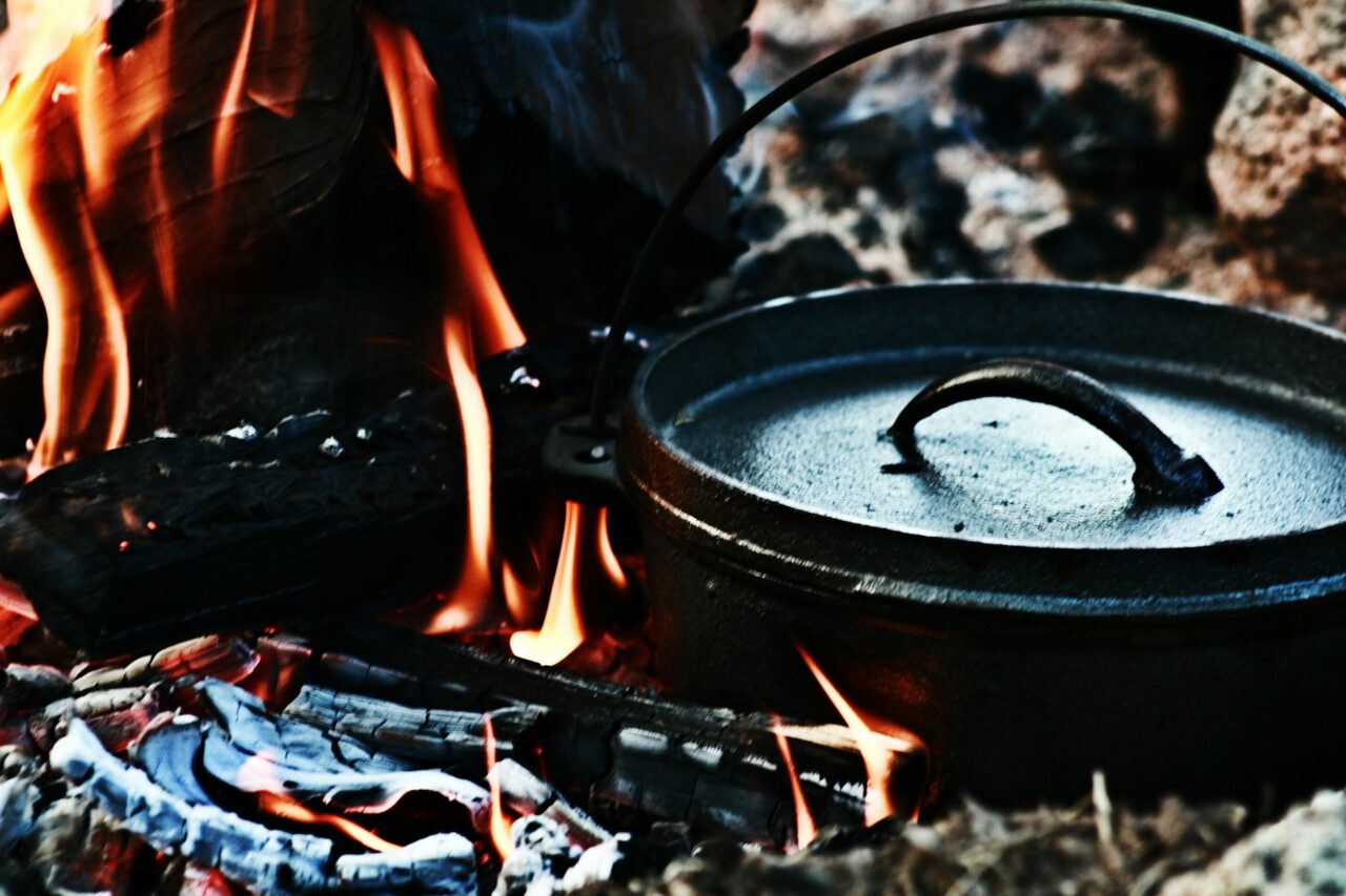 Dutch oven - black metal pot on a camp fire