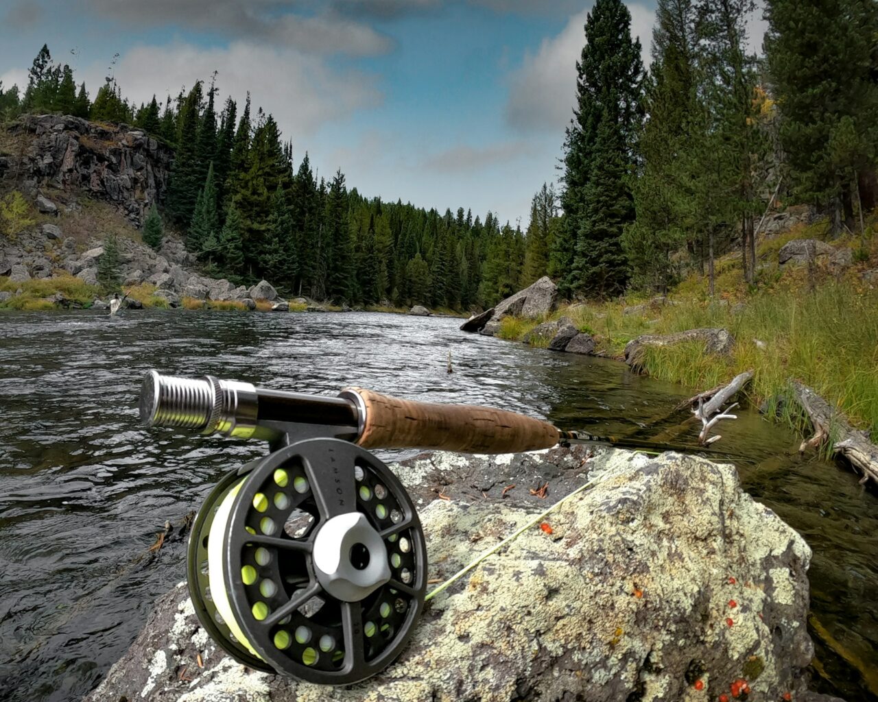 Fishing reel on a rock next to a river in Idaho