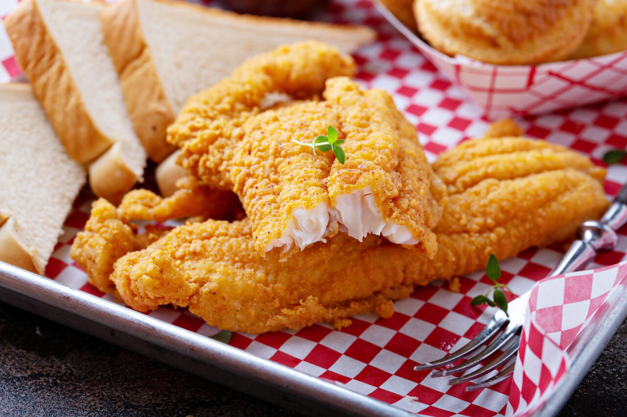 Fried catfish and bread on a tray