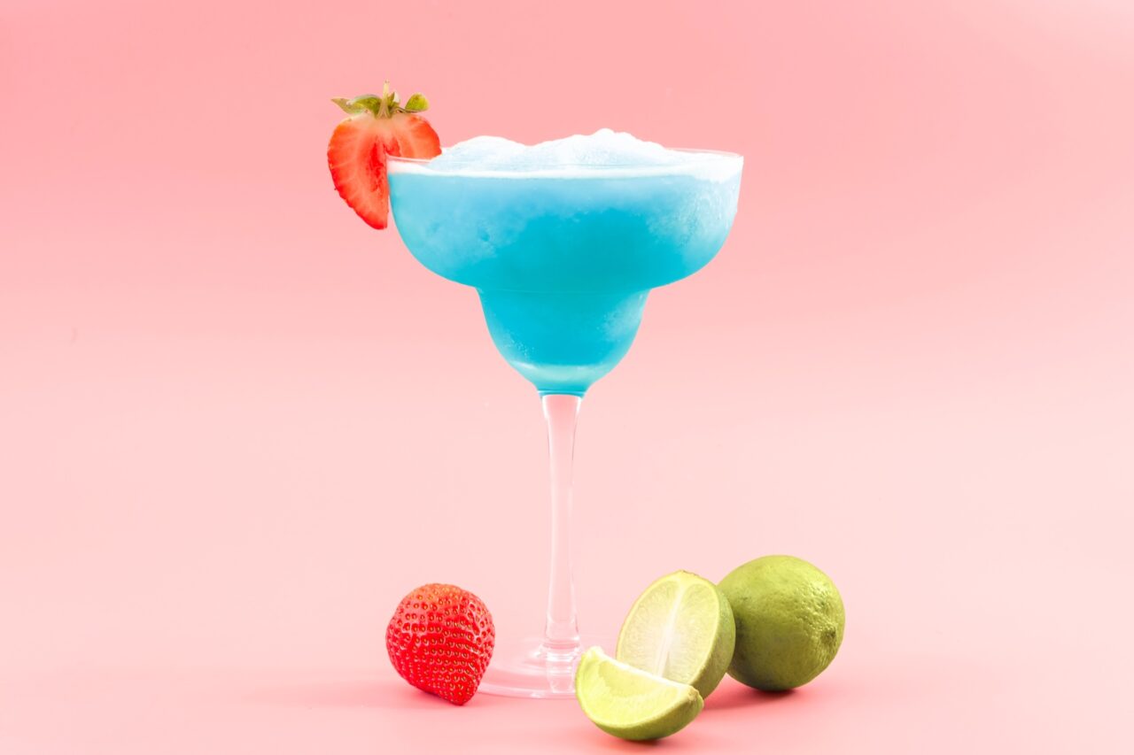 Frozen blue margarita in pink background
