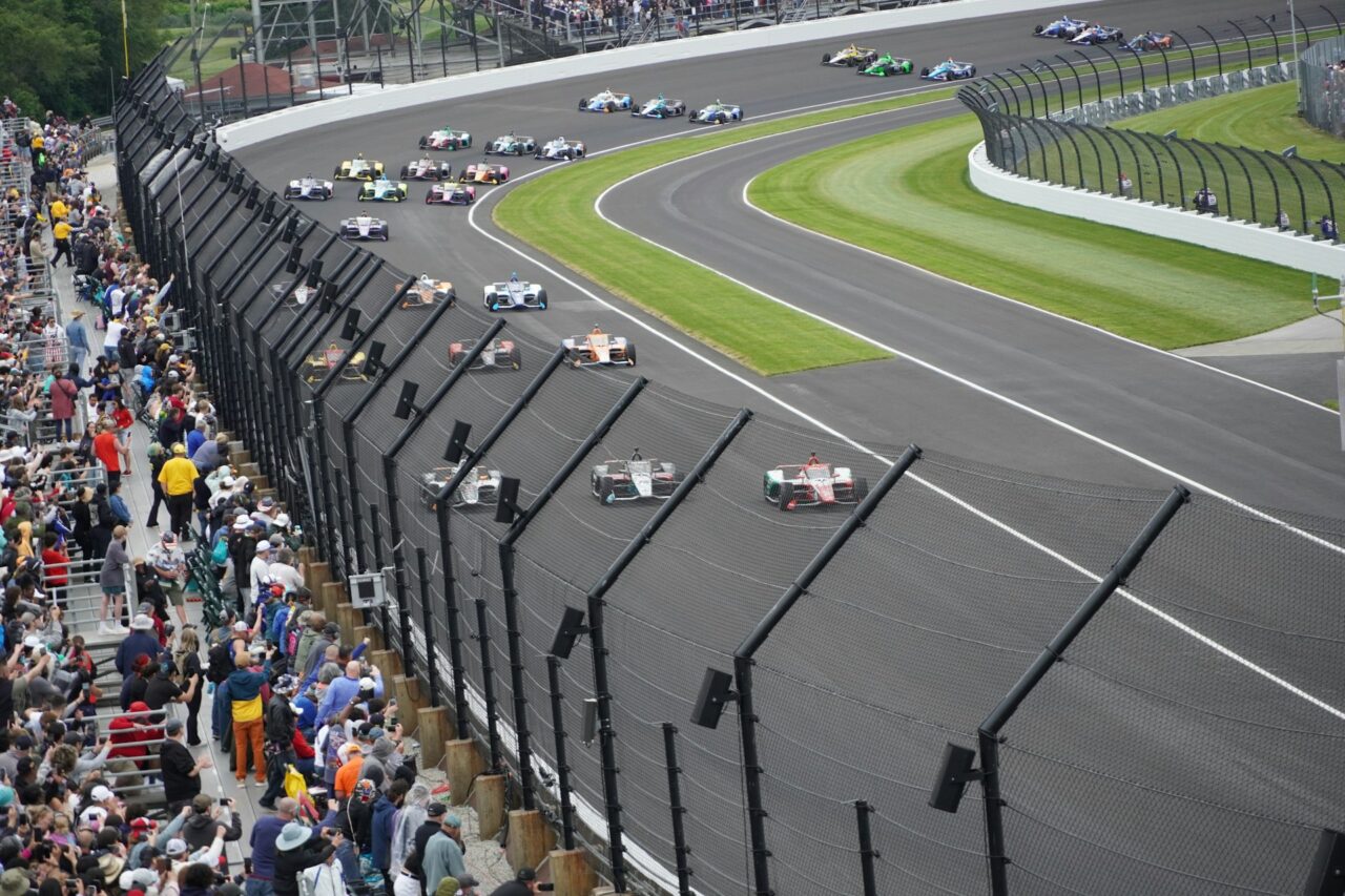 Racing cars racing around the track at Indianapolis Motor Speedway