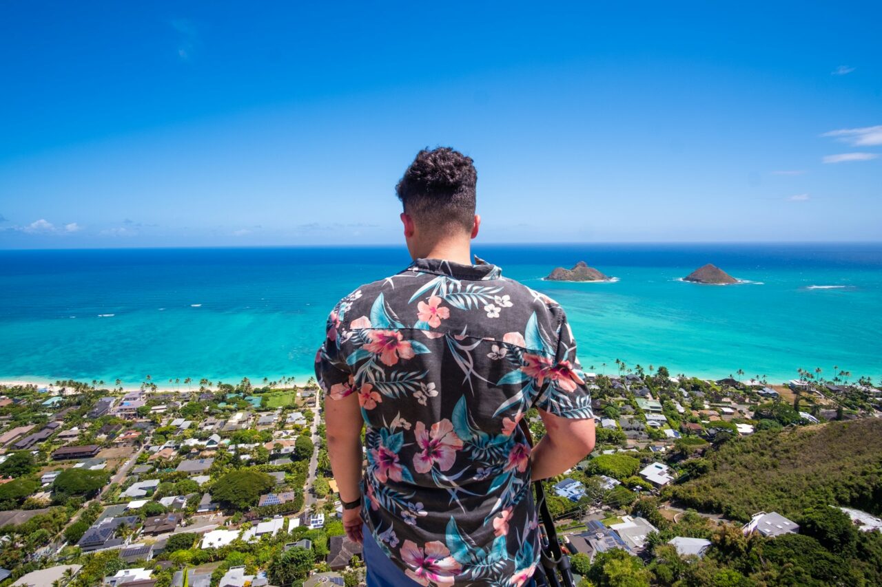 Man wearing a Hawaiian shirt looking out at Lanikai Beach