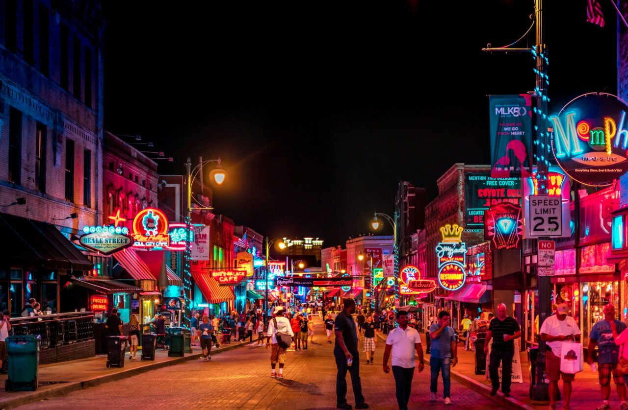 People walking down Beale Street at night in Memphis