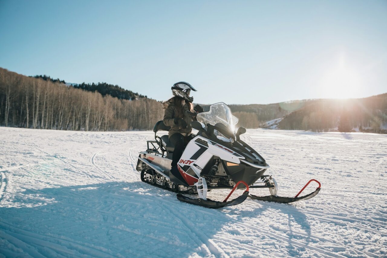 Person riding a snowmobile on snow