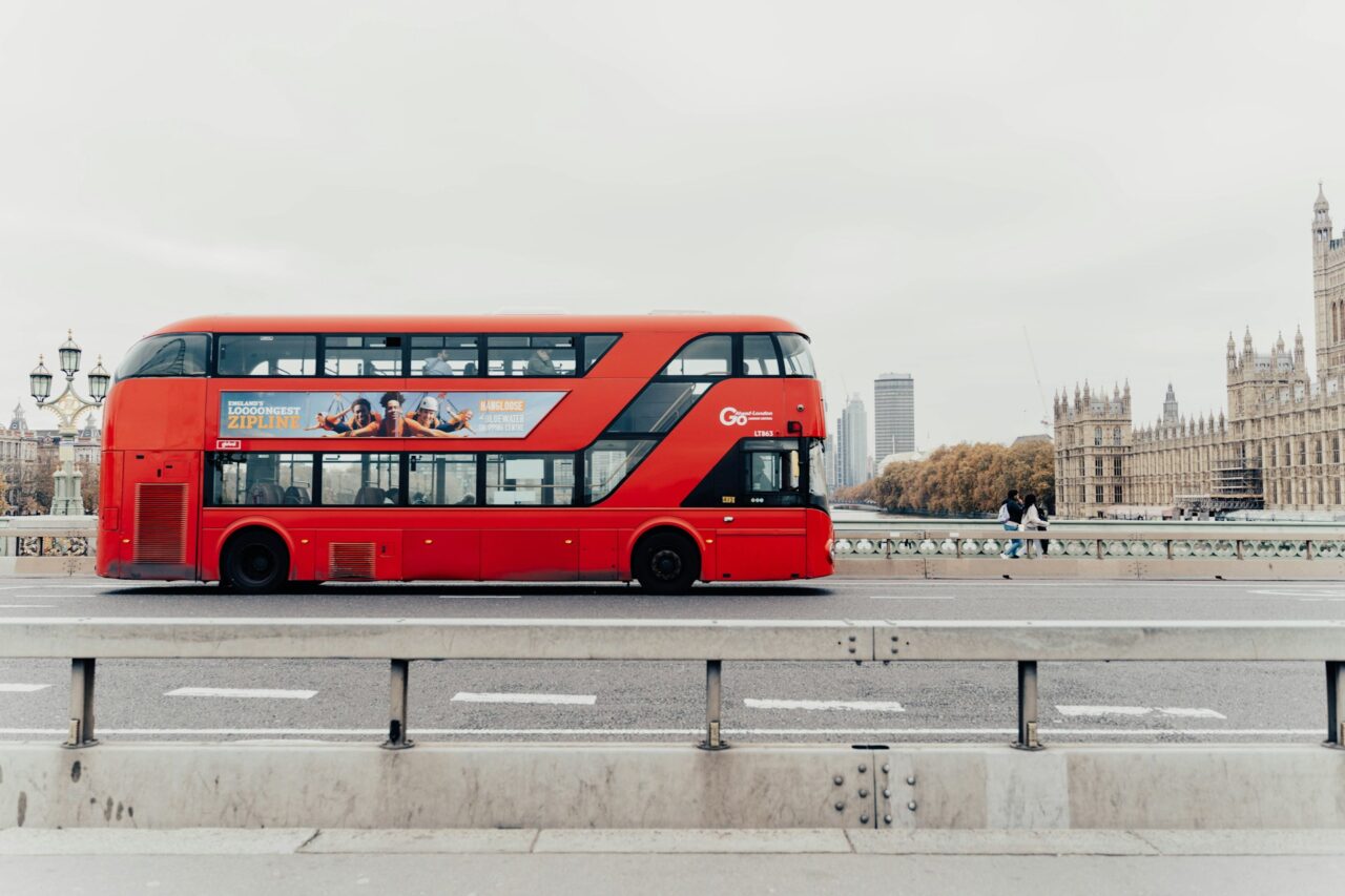 Red bus crossing a bridge in London