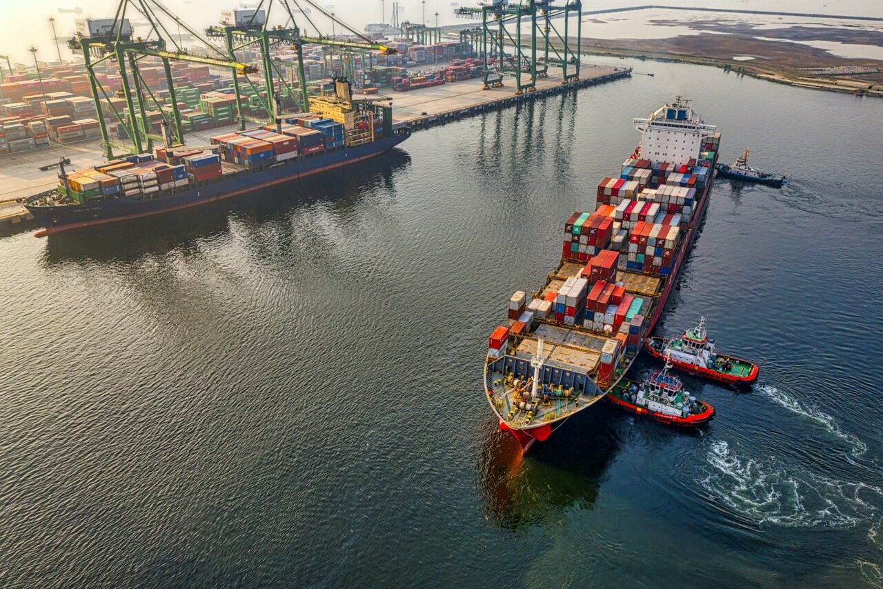 Two ships loaded with colorful shipping containers on the water. 