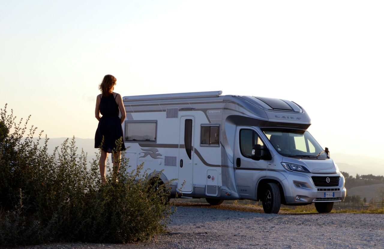 Woman standing next to a motorhome in Tuscany