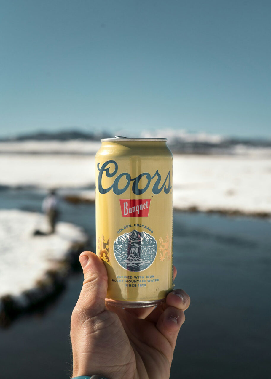 Hand holding a Coors Banquet beer