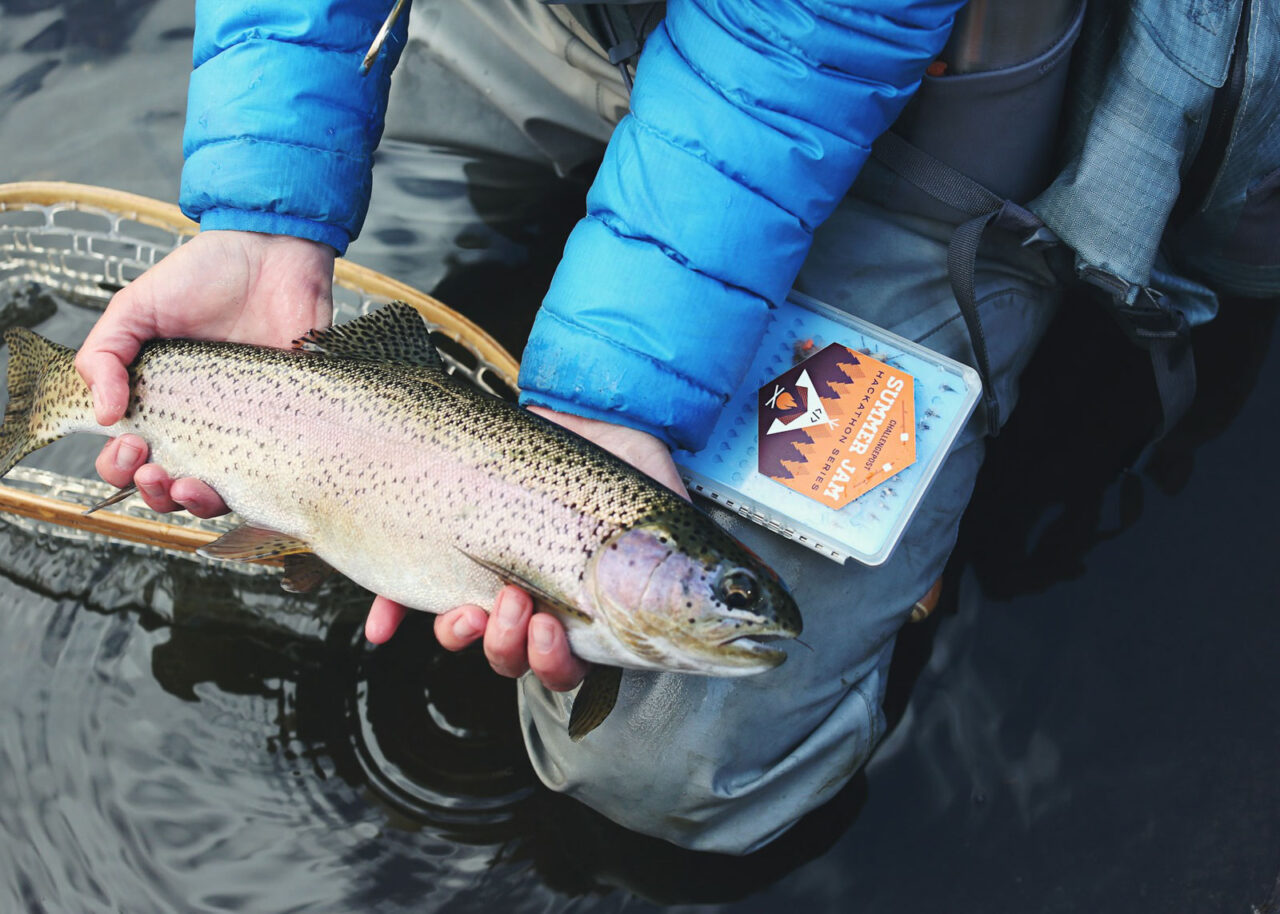 Fisherman holding rainbow trout in Colorado