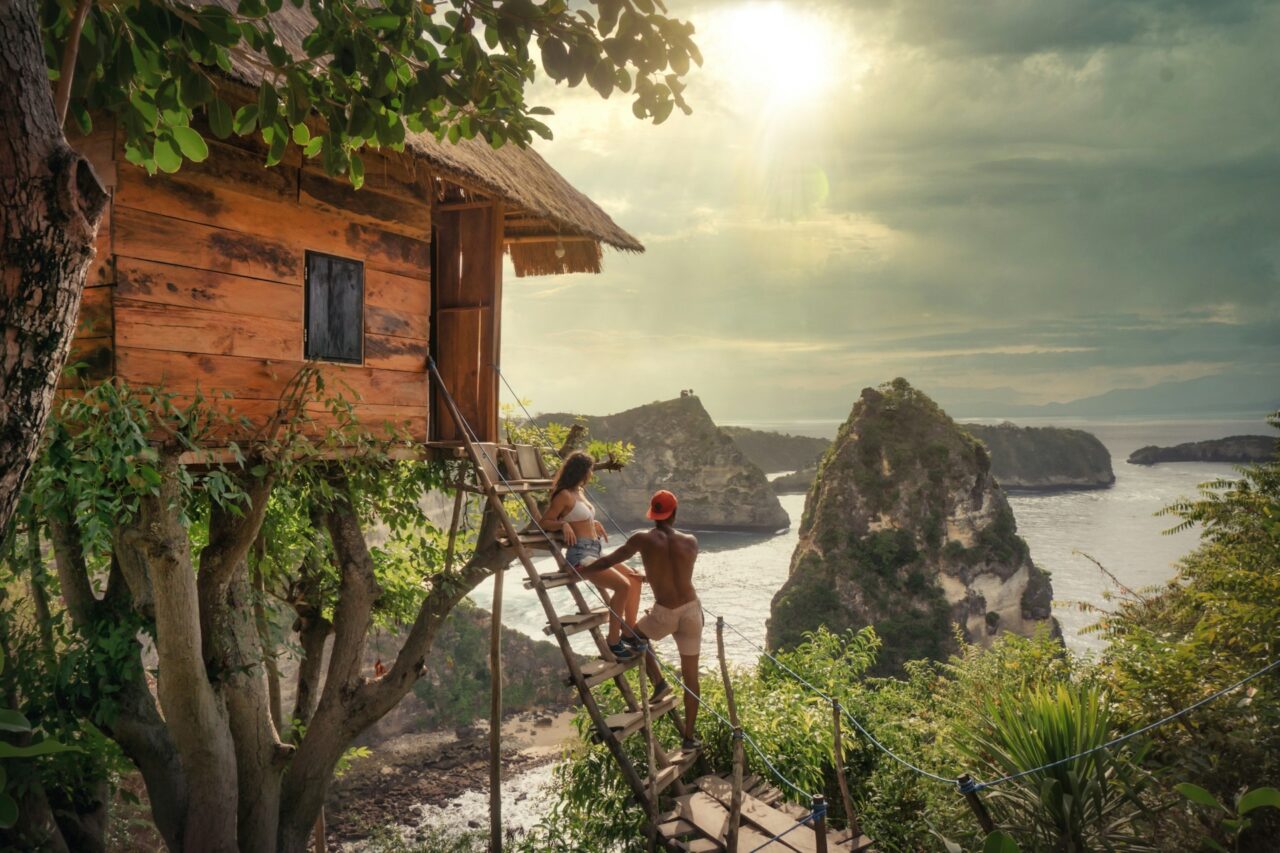 Couple standing on the steps of a treehouse in Nusa Penida