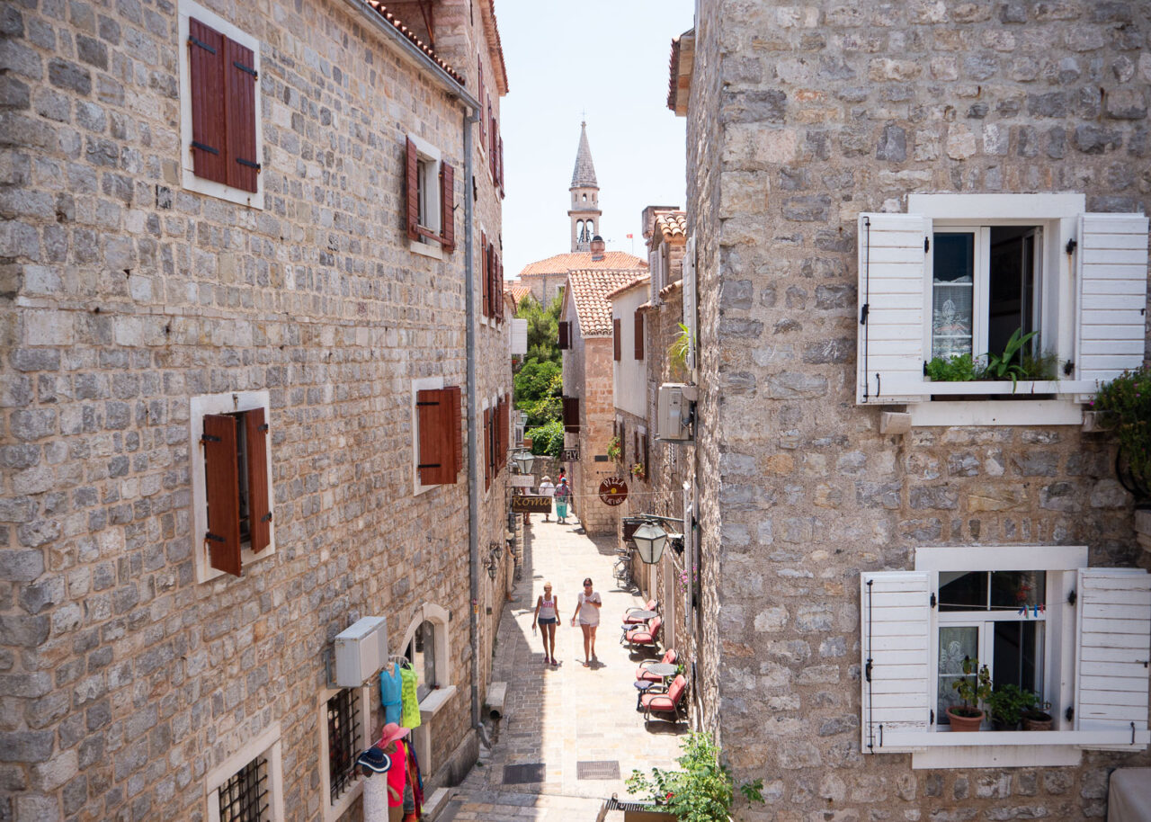 Narrow street of Budva Old Town with the citadel in the distance