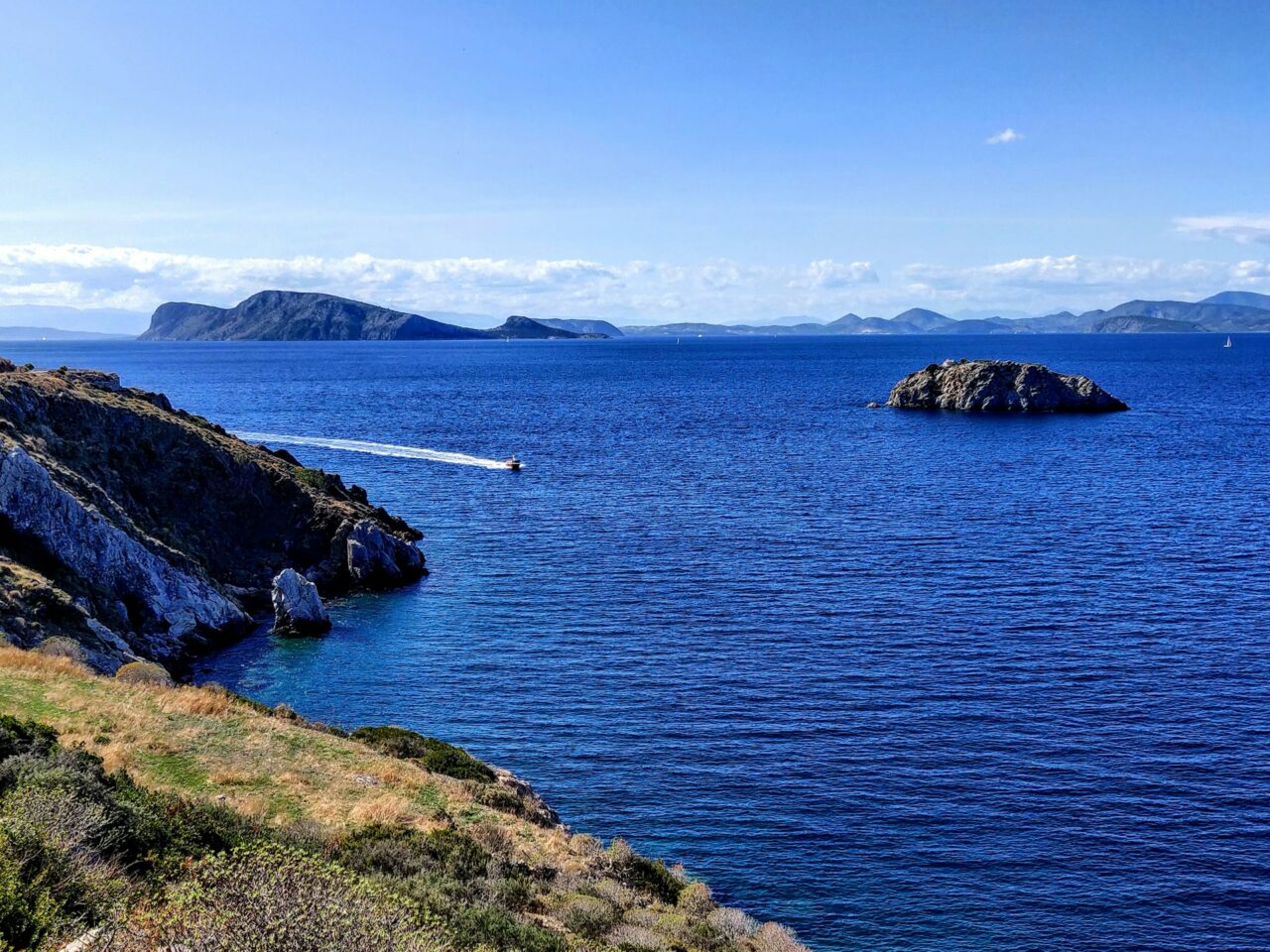Rocky coastline and blue ocean in Hydra, Greece