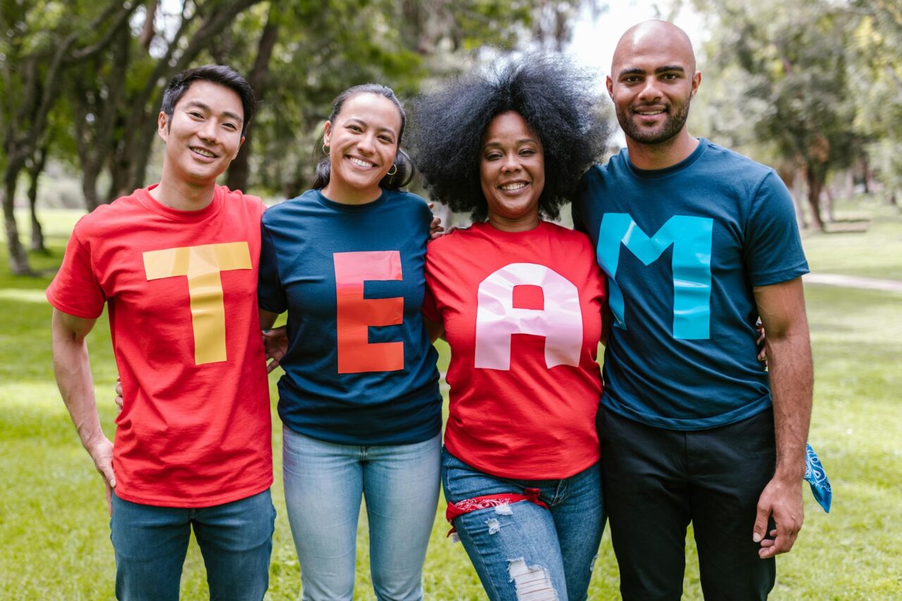 Group of people wearing T-shirts that spell "team"