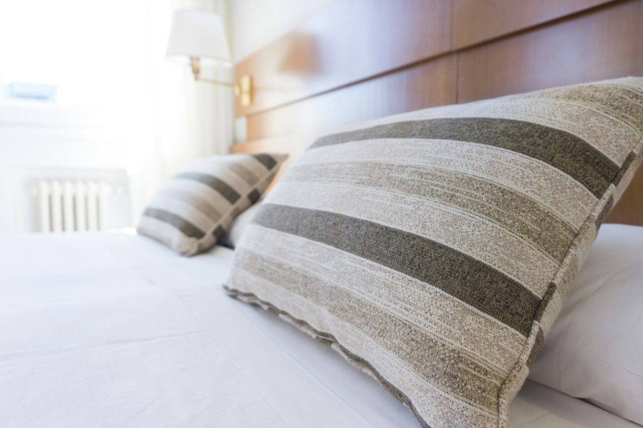 Close up of a hotel bed with striped pillows