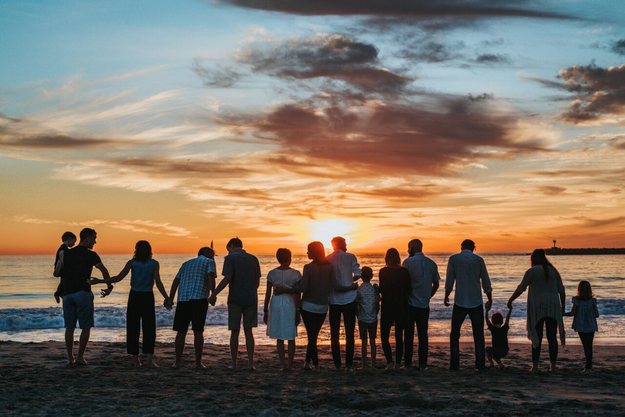 Family with kids on a beach at sunset