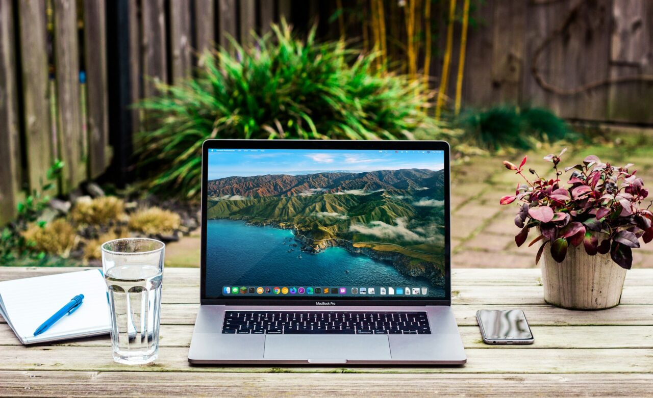 Macbook pro open on a wooden bench