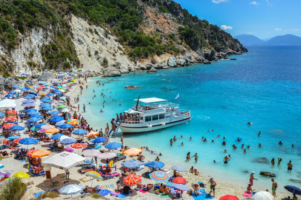 Busy beach crowded with people in Lefkada, Greece