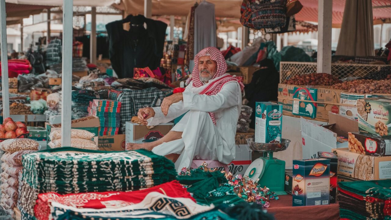 Man wearing traditional dress on a market stall in Saudi Arabia