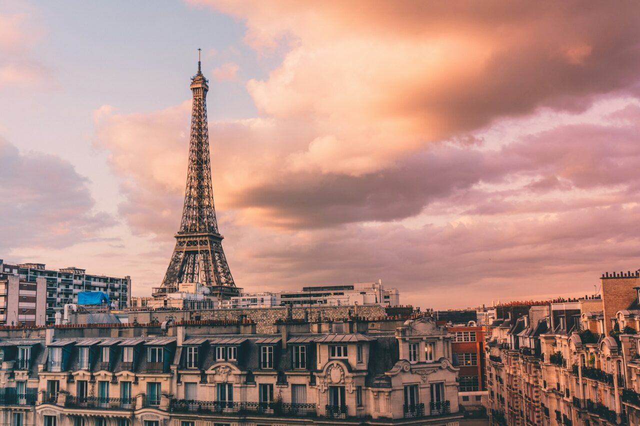 Eiffel Tower and buildings at sunset with pink sky