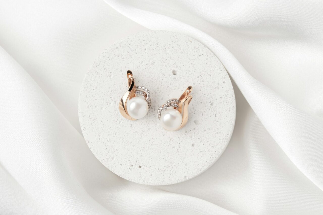 Pearl earrings with diamond and gold on a white background